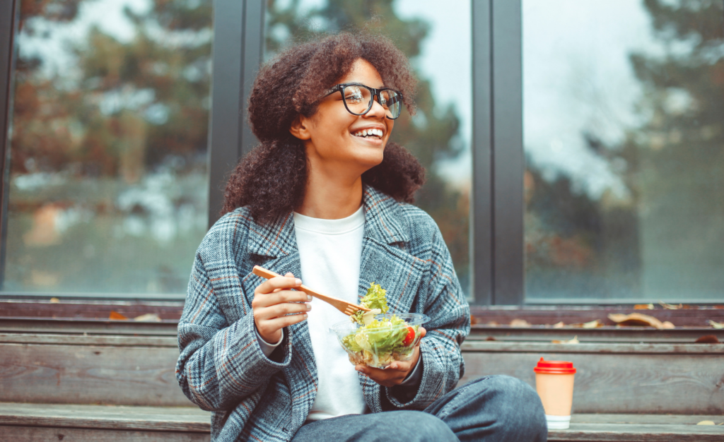 Woman Eating a Salad thinking about the history behind it